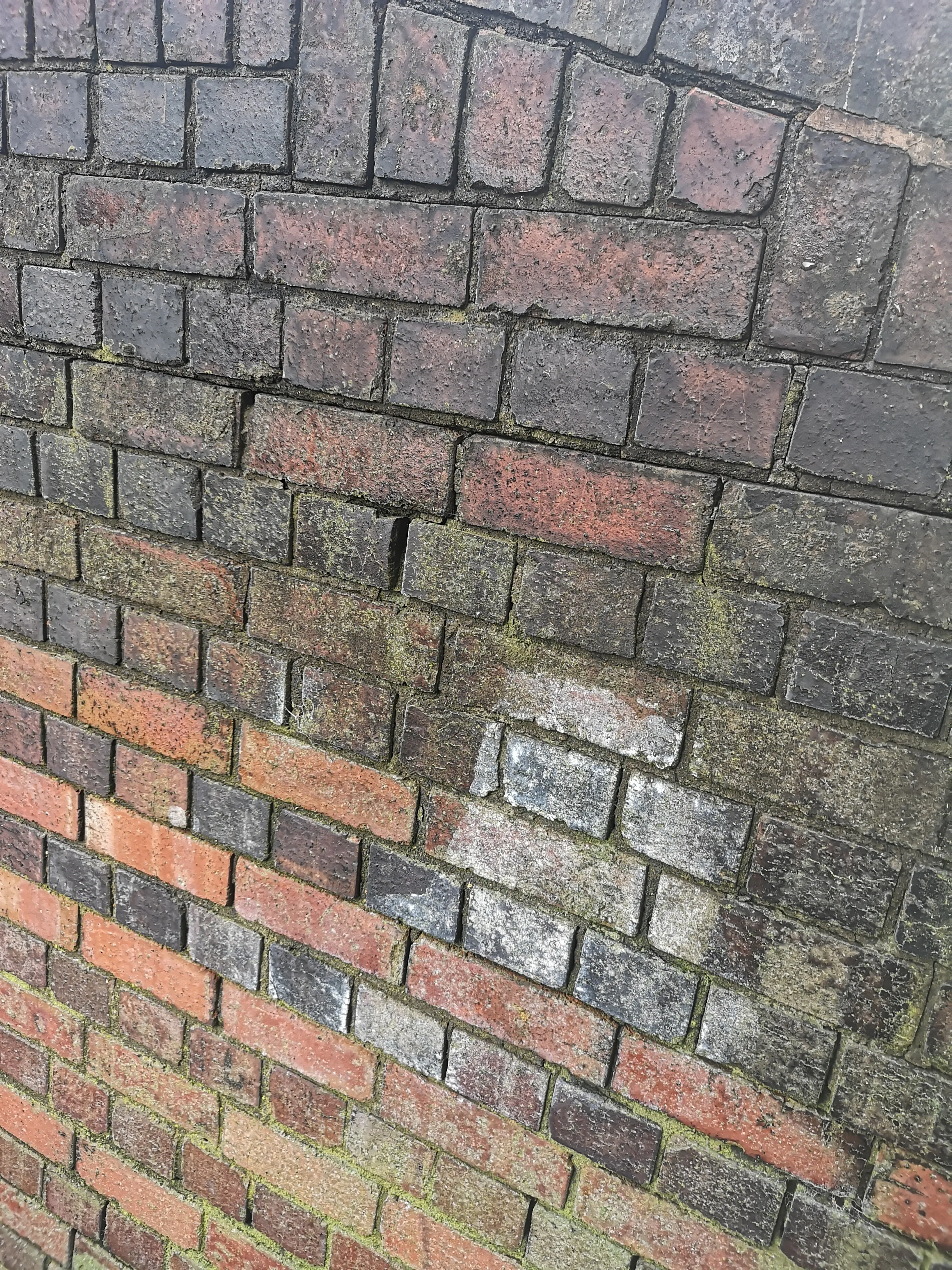Close-up of weathered red and grey brick sidings at Brierley Hill, showing texture and age